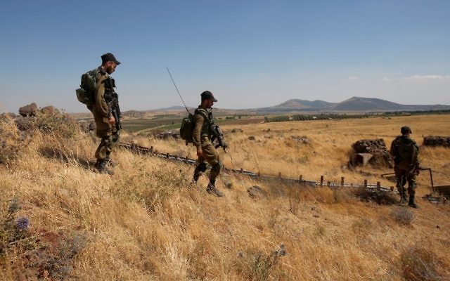 Israeli soldiers patrol near the border with Syria after projectiles fired from the war-torn country hit the Israeli Golan Heights on June 24, 2017. (AFP PHOTO / JALAA MAREY)