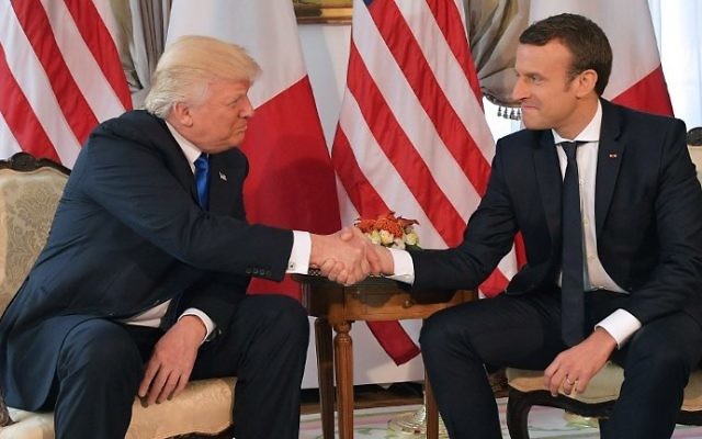 US President Donald Trump (L) and French President Emmanuel Macron shaking hands at the US ambassador's residence in Brussels, May 25, 2017. (AFP Photo/Mandel Ngan)
