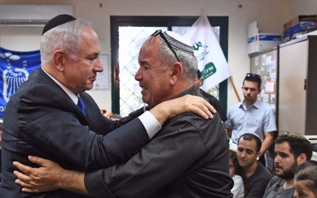 Prime Minister Benjamin Netanyahu (l) hugs David Malka, father of slain Border Police officer Hadas Malka on June 18, 2017. (Koby Gideon/GPO)