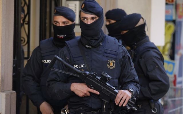 Illustrative: Spanish police officers prior to arresting an unidentified man in Barcelona, Spain on April 25, 2017. (AP Photo/Manu Fernandez)