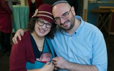 Rabbi Sarah Mulhern with her husband Rabbi Will Friedman and newborn baby. (Courtesy of Mulhern/via JTA)