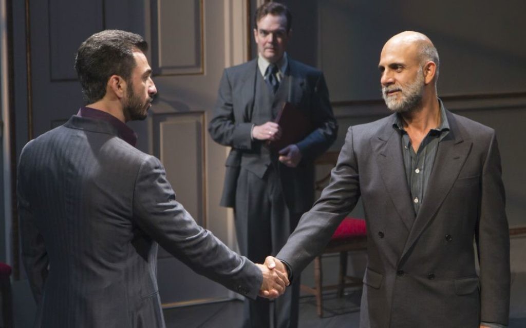 Michael Aronov and Anthony Azizi shake hands,  Jefferson Mays in the background in 'OSLO.' (Courtesy/T. Charles Erickson)