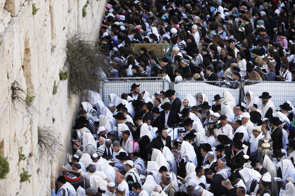 Jewish women and men pray in front of the Western Wall in Jerusalem's Old City, during the Cohen Benediction priestly blessing at the Jewish holiday of Passover, April 09, 2012. (Miriam Alster/Flash90)