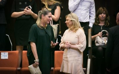 Michal Herzog, wife of opposition leader Isaac Herzog, speaks to Sara Netanyahu at the opening of the winter session of the Knesset on October 12, 2015 (Miriam Alster/FLASH90)