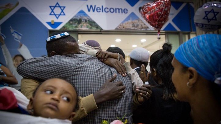 Family members greet new arrivals from Ethiopia at Ben Gurion Airport on June 6, 2017. (Miriam Alster/Flash90)