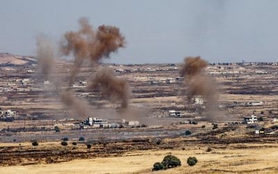 A picture taken from the Israeli side of the border shows smoke rising near the Israeli-Syrian border on the Golan Heights during fights between the rebels and the Syrian army inside Syria, June 25, 2017. (Basel Awidat/Flash90)