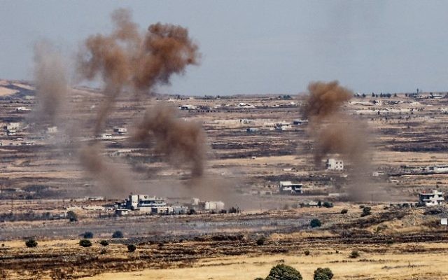 A picture taken from the Israeli side of the border shows smoke rising near the Israeli-Syrian border in the Golan Heights during fights between the rebels and the Syrian army, June 25, 2017. (Basel Awidat/Flash90)