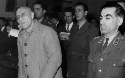 In this Dec. 21, 1953 file photo, former Iranian PM Mohammed Mosaddegh, left, is sentenced to three years solitary confinement by a military court after findidng him guilty on 13 charges of acting against the Shah, in Tehran, Iran. (AP Photo, File)