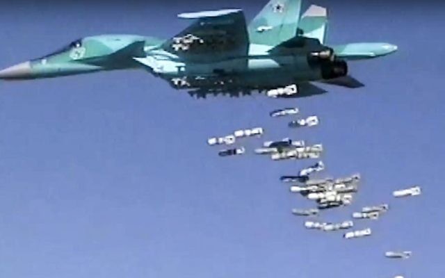 Image made from video provided by the Russian Defense Ministry press service on August 18, 2016, shows a Russian combat fighter bomber Su-34 unload its bombs over a target in Syria. (Russian Defense Ministry Press Service photo via AP, File)