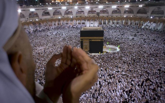 A Muslim worshipper prays during Laylat al-Qadr, Night of Decree, on the 27th day of the holy fasting month of Ramadan as pilgrims circumambulate around the Kaaba, the cubic building at the Grand Mosque, during the minor pilgrimage, known as Umrah, in the Muslim holy city of Mecca, Saudi Arabia, June 22, 2017. (AP Photo/Amr Nabil)