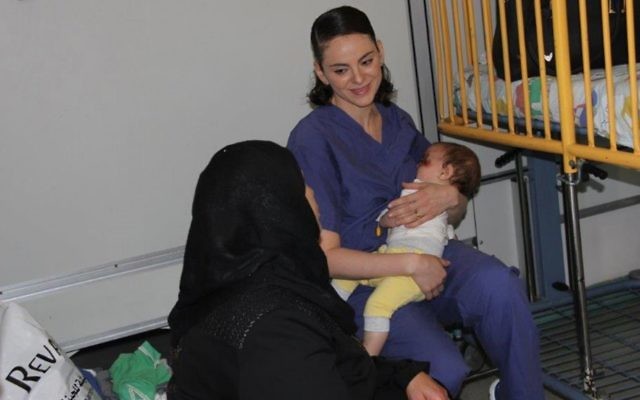 Nurse Ula Ostrowski-Zak cares for a nine-month-old Palestinian boy at Hadassah Ein Kerem Hospital in Jerusalem. (Hadassah spokesperson)