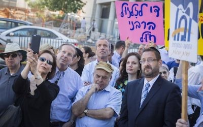 Then-Jewish Agency chairman Natan Sharansky, center, in brown cap, and then-Knesset member Dov Lipman, in jacket and tie at right, at a protest held by American and Israeli Orthodox and Conservative Jews outside the Chief Rabbinate offices in Jerusalem, July 6, 2016. (Hadas Parush/Flash90)