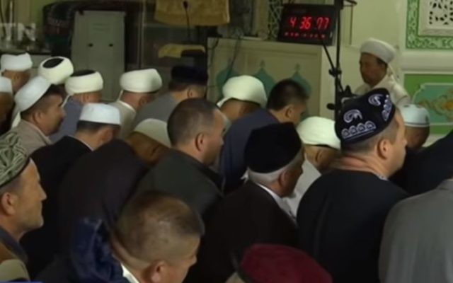 Muslims in China's Xinjiang province gather for prayers during Ramadan, May 2017. (Screen capture: YouTube)