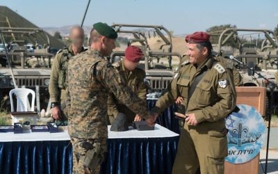 The commander of the IDF's Commando Brigade, Col. David Zini, shakes hands with an officer of the Cypriot military during an exercise in Cyprus in June 2017. (IDF Spokesperson's Unit)