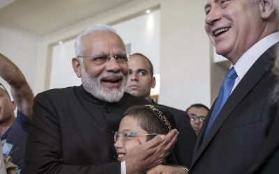 Indian Prime Minister Narendra Modi (C-L) embraces Moshe Holtzberg (C), son of slain US Rabbi Gavriel Holtzberg who was killed with his wife in the November 26, 2008 attacks on the Nariman Chabad house in Mumbai, on July 5, 2017. (AFP Photo/Pool/Atef Safadi) 