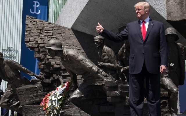 US President Donald Trump holds his thumb up as he stands in front of the Warsaw Uprising Monument on Krasinski Square during the Three Seas Initiative Summit in Warsaw, Poland, July 6, 2017. (AFP/Saul Loeb)