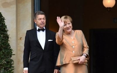 German chancellor Angela Merkel (R) and her husband Joachim Sauer arrive at the Festival Theatre on July 25, 2017, in Bayreuth, southern Germany, ahead of the opening of Bayreuth's legendary annual opera festival dedicated to the works of Richard Wagner. (AFP PHOTO / Christof STACHE)