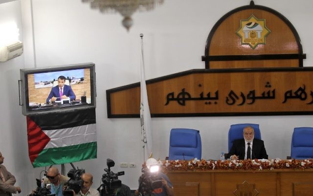 Hamas' MP and head of the parliament in Gaza City Ahmad Bahar (R) chairs a  Palestinian legislative Council meeting in Gaza City as exiled former senior Fatah member Mohammed Dahlan attends it through video conference from the United Arab Emirates on July 27, 2017.
( AFP PHOTO / SAID KHATIB)