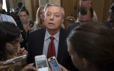 Sen. Lindsey Graham, R-S.C. is surrounded by reporters as he arrives at the Senate chamber on Capitol Hill in Washington, Thursday, July 27, 2017. (AP Photo/J. Scott Applewhite)