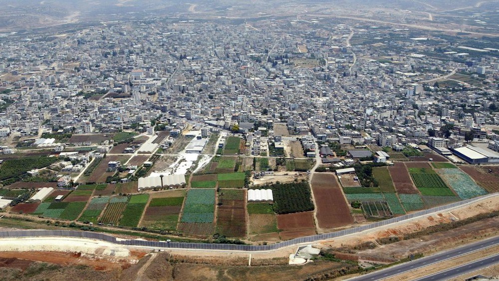 The Palestinian city of Qalqilya (top) and the Israeli security barrier (bottom), file photo (AP Photo/Lefteris Pitarakis)