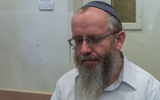 Rabbi Ezra Sheinberg is brought for a court hearing at the Kiryat Shmona Magistrates Court on July 2, 2015. (Basel Awidat/Flash90)