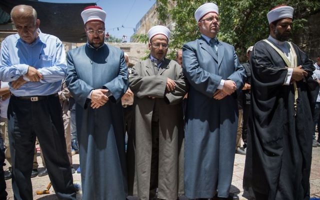File: Waqf officials and others prepare to pray outside the Temple Mount, in Jerusalem's Old City, rather than enter the compound via metal detectors set up by Israel following a terror attack, July 16, 2017. (Yonatan Sindel/Flash90)