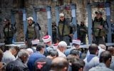 Waqf officials lead Muslim prayers outside the Temple Mount in Jerusalem's Old City on July 16, 2017 after refusing to go through metal detector gates set up by Israeli police. (Yonatan Sindel/Flash90)