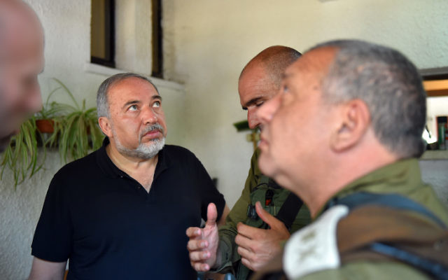 Defense Minister Avigdor Liberman (left) and IDF Chief of Staff Gadi Eisenkot (right) visit the site of a terror attack in the settlement of Halamish, July 22, 2017 (Ariel Hermoni/Ministry of Defense/Flash90)
