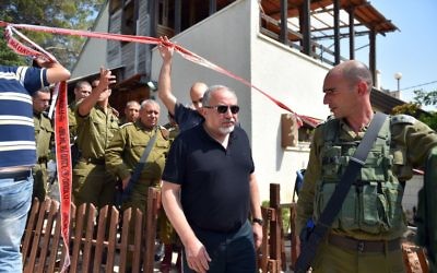 Defense Minister Avigdor Liberman, center at the site of a terror attack in the settlement of Halamish, where three Israelis were murdered and one seriously injured by a Palestinian in a stabbing attack. July 22, 2017. (Hermoni/Ministry of Defense) 