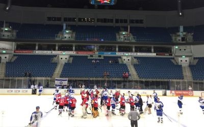 Russian (in red) and Israeli Maccabiah teams shaking hands after Sunday's match, which ended 5 to 3, Russia (Jessica Steinberg/Times of Israel)