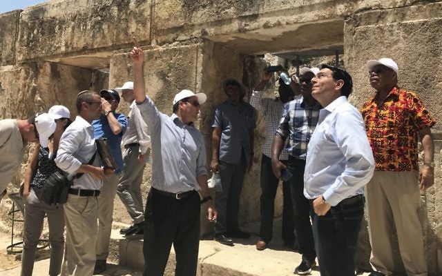Jerusalem Mayor Nir Barkat, center, gestures as Israel's UN envoy Danny Danon, second right, looks on during a visit by UN ambassadors from nine countries who toured the City of David in Jerusalem, July 4, 2017. (Arnon Bossani and Frayda Leibtag)