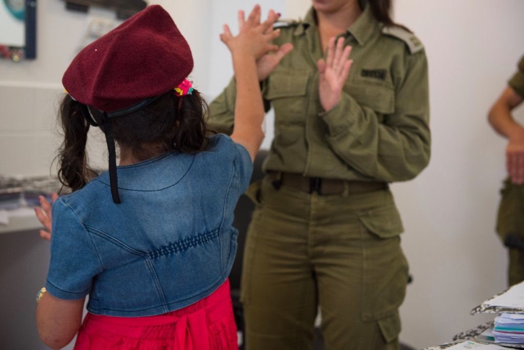 In this undated photo provided on July 19, 2017, an IDF officer attends to a Syrian child as part of the army's 'Good Neighbor' program to provide humanitarian aid for Syrian civilians on the Syrian Golan Heights. (IDF spokesperson)