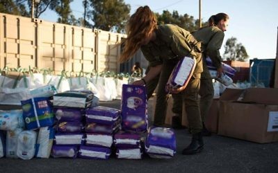 In this undated photo provided on July 19, 2017, IDF soldiers prepare humanitarian aid as part of the army's 'Good Neighbor' program for Syrian civilians on the Syrian Golan Heights. (Israel Defense Forces)