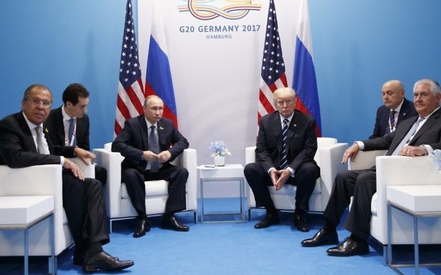 In this Friday, July 7, 2017, file photo, US President Donald Trump meets with Russian President Vladimir Putin at the G20 Summit, in Hamburg. Russian Foreign Minister Sergey Lavrov is at left, Secretary of State Rex Tillerson is at right. (AP Photo/Evan Vucci)