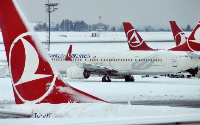 In this January 10, 2017, photo, Turkish Airlines aircraft are stationed at Ataturk International Airport covered in snow, in Istanbul, Turkey. (Faik Kaptan/Depo Photos via AP)