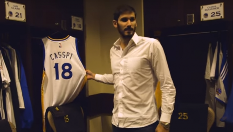 Israeli basketball star Omri Casspi is shown his new jersey for the NBA champion Golden State Warriors after signing with the team on July 12, 2017. (Screen capture: YouTube)