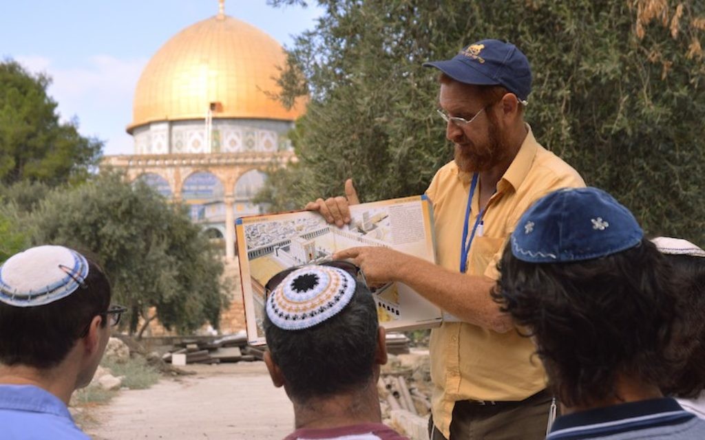 On a tour of the Temple Mount, Yehuda Glick shows religious Jews a diagram of the Jewish temple, which once stood where the golden Dome of the Rock stands today  on Sepetember 17, 2013 in Jerusalem Israel. (Photo by Christa Case Bryant/The Christian Science Monitor via Getty Images via JTA)