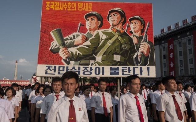 A propaganda poster is displayed during a rally in support of North Korea's stance against the US, on Kim Il-Sung square in Pyongyang on August 9, 2017. 
(AFP /KIM Won-Jin)