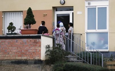 People ring the doorbell of the apartment of the Oukabir family in Ripoll, after police carried out a search linked to the deadly terror attacks in Barcelona and the seaside resort of Cambrils on August 18, 2017, a day after a van plowed into the crowd, killing 13 persons and injuring over 100 on the Rambla in Barcelona.(AFP PHOTO / PAU BARRENA)