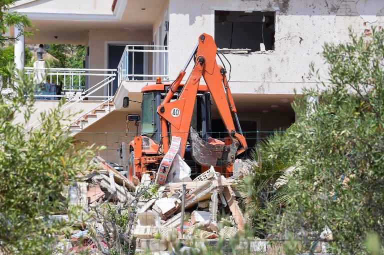 A picture taken on August 20, 2017 shows a crane in the rubble of a house,where suspects of this week's twin assaults in Spain were believed to be building bombs, in Alcanar. (AFP PHOTO / JOSE JORDAN)