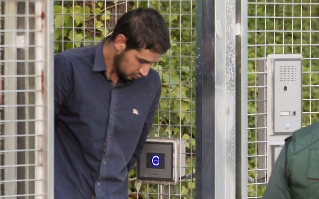 Salah El Karib, suspected of involvement in the terror cell that carried out twin attacks in Spain, is escorded by Spanish Civil Guards from a detention center in Tres Cantos, near Madrid, on August 22, 2017 before being transferred to the. National Court (AFP PHOTO / STRINGER)