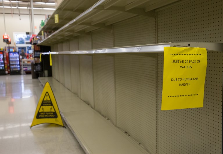 An Austin area grocer shelves are empty as they keep bottled water and other essential items stocked and sell limited quantities on August 27, 2017, during the aftermath of Hurricane Harvey which hit the Texas Golf coast. (AFP PHOTO / SUZANNE CORDEIRO)