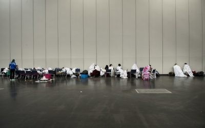 Flood victims are seen at a shelter in the George R. Brown Convention Center during the aftermath of Hurricane Harvey on August 28, 2017 in Houston, Texas. (AFP PHOTO / Brendan Smialowski)