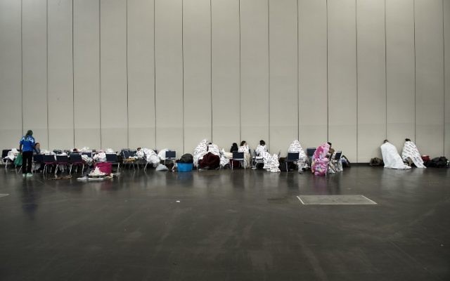 Flood victims are seen at a shelter in the George R. Brown Convention Center during the aftermath of Hurricane Harvey on August 28, 2017 in Houston, Texas. (AFP PHOTO / Brendan Smialowski)