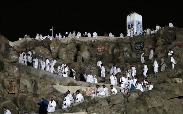 Muslim pilgrims walk and pray on Mount Arafat, also known as Jabal al-Rahma (Mount of Mercy), southeast of the Saudi holy city of Mecca, on the eve of Arafat Day which is the climax of the Hajj pilgrimage on August 30, 2017. (Karim Sahib/AFP)