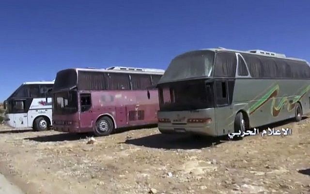 This frame grab from video released on Monday, July 31,2017 and provided by the government-controlled Syrian Central Military Media, shows buses gathering near the Lebanese border town of Arsal. (Syrian Central Military Media, via AP) 