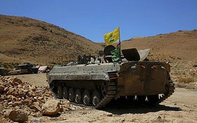A Hezbollah armored vehicle sits at the site where clashes erupted between Hezbollah and al-Qaeda-linked fighters in Wadi al-Kheil or al-Kheil Valley in the Lebanon-Syria border,  July 29, 2017. (AP Photo/Bilal Hussein)