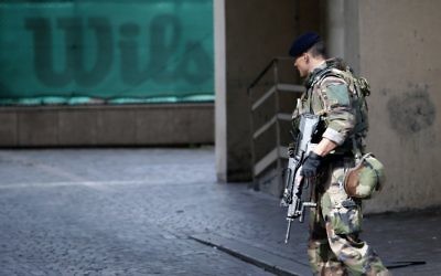 French police officers stand near the scene where French soldiers were hit and injured by a vehicle in the western Paris suburb of Levallois-Perret near Paris, France, Wednesday, Aug. 9, 2017. (AP Photo/Kamil Zihnioglu)