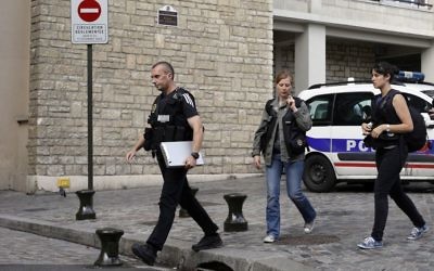 French police officers work on the scene where French soldiers were hit and injured by a vehicle in the western Paris suburb of Levallois-Perret near Paris, France, Wednesday, Aug. 9, 2017. (AP Photo/Kamil Zihnioglu)