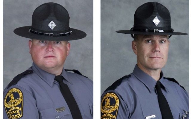 These undated photo provided by the Virginia State Police show Trooper-Pilot Berke M.M. Bates, left, of Quinton, Va., and Lt. H. Jay Cullen, of Midlothian, Va. The two were killed Saturday, Aug. 12, 2017, when the helicopter they were piloting crashed while assisting public safety resources during clashes at a nationalist rally in Charlottesville, Va. (Virginia State Police via AP)